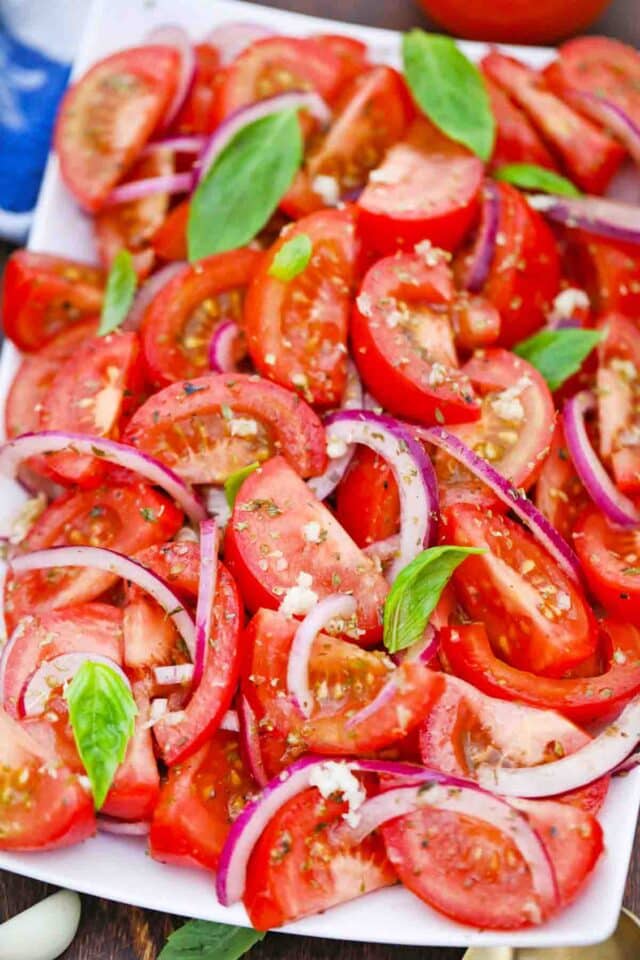 overhead shot of a serving plate with onion tomato salad