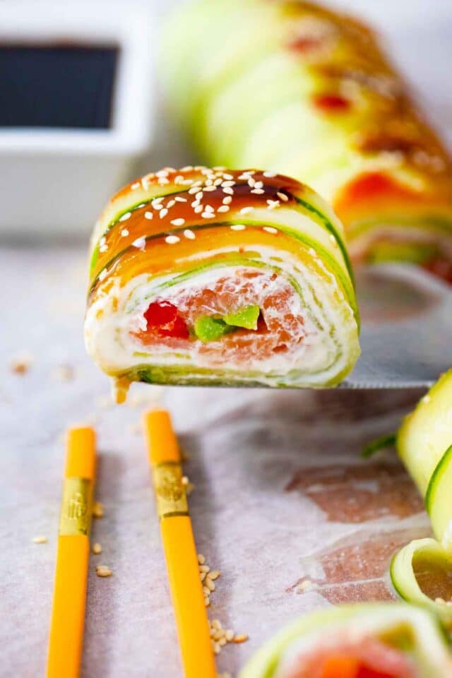 lifting a cucumber sushi roll piece on a serving spatula