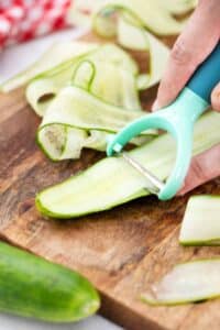 thinly slicing an English cucumber