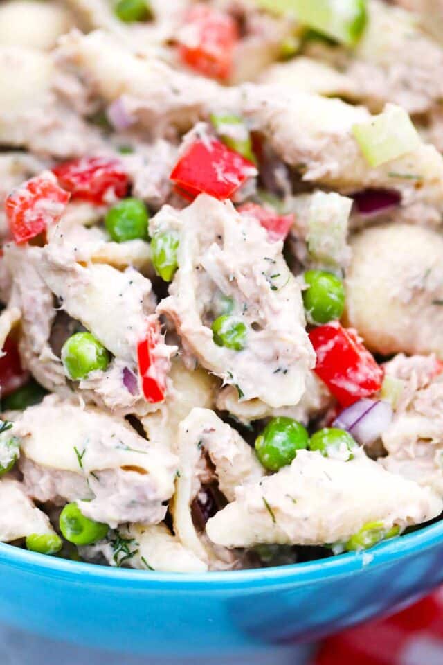 close shot of tuna pasta salad with bell peppers and sweet peas