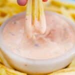 dipping three fries in creamy in n out sauce