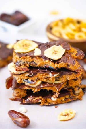 peanut butter date bark pieces stacked on top of each other