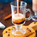pouring mocha latte in a glass cup