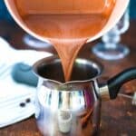 pouring mocha latte in a small coffee pot