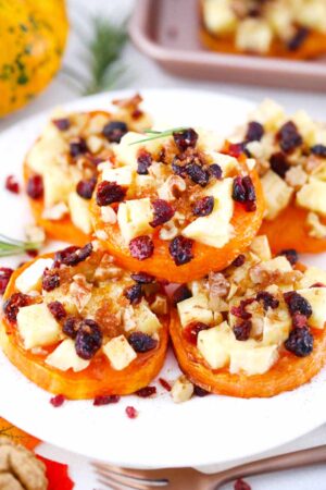 a stack of butternut squash brie rounds on a serving plate