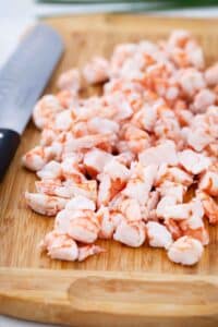chopped cooked shrimp on a cutting board