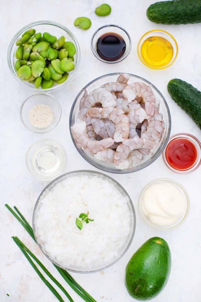 overhead shot of shrimp poke bowl ingredients in bowls on a table