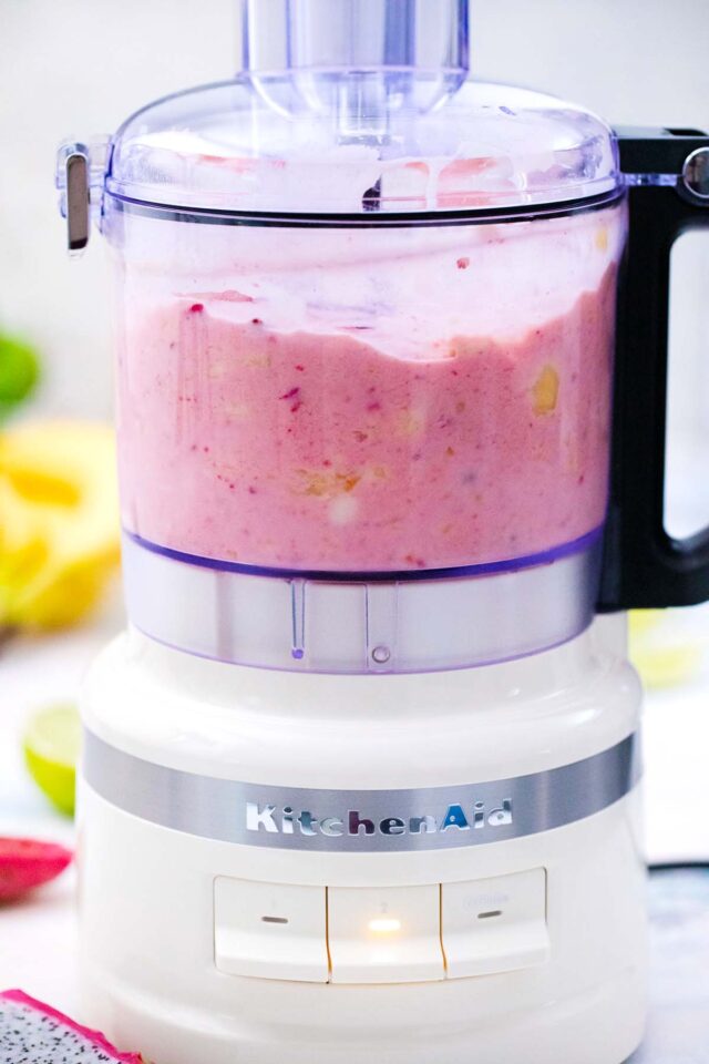 mixing dragon fruit smoothie in a belnder