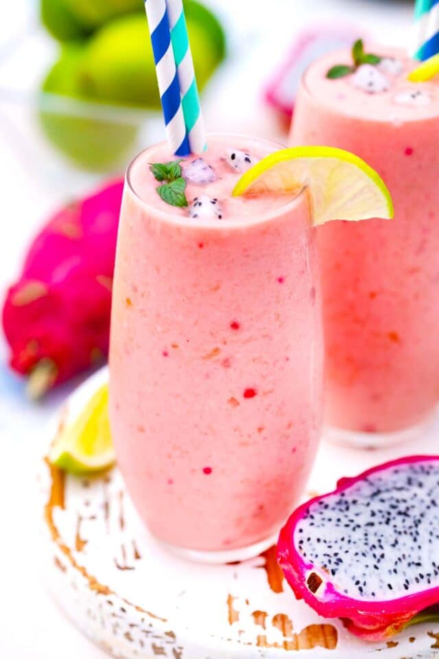 dragon fruit smoothie in tall glasses with a straw