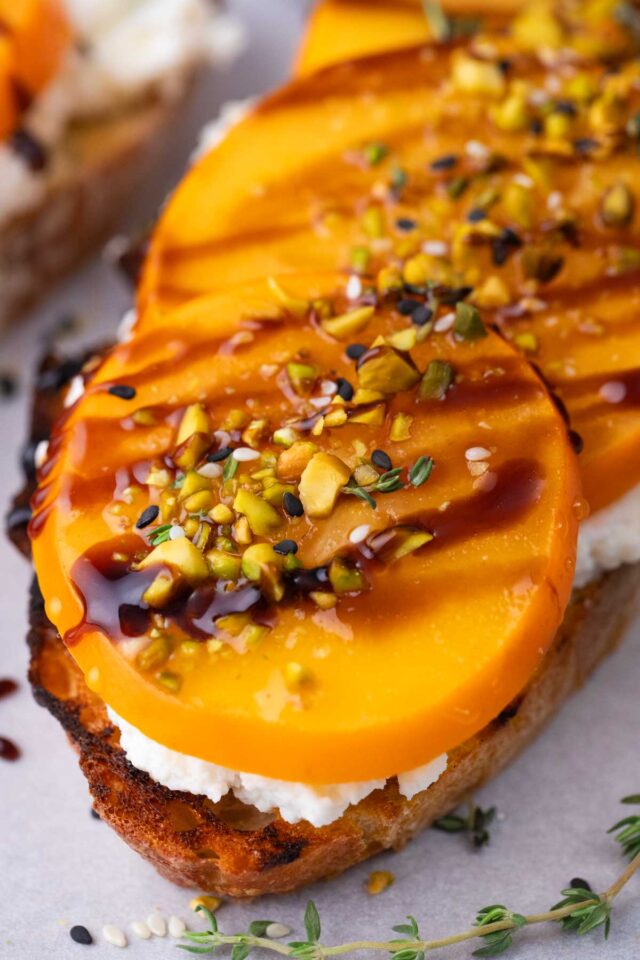 homemade persimmon toast with ricotta, balsamic reduction and chopped pistachios