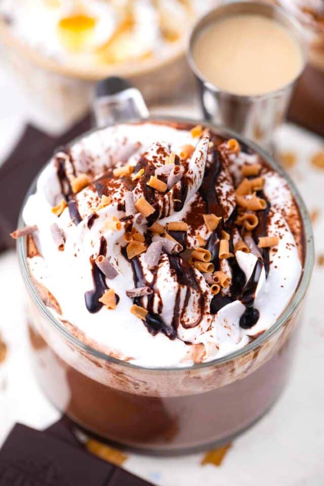 baileys hot chocolate topped with whipped cream and chocolate shavings