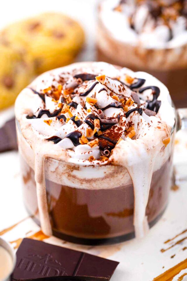 baileys hot chocolate with whipped cream, chocolate sauce, and chocolate shavings