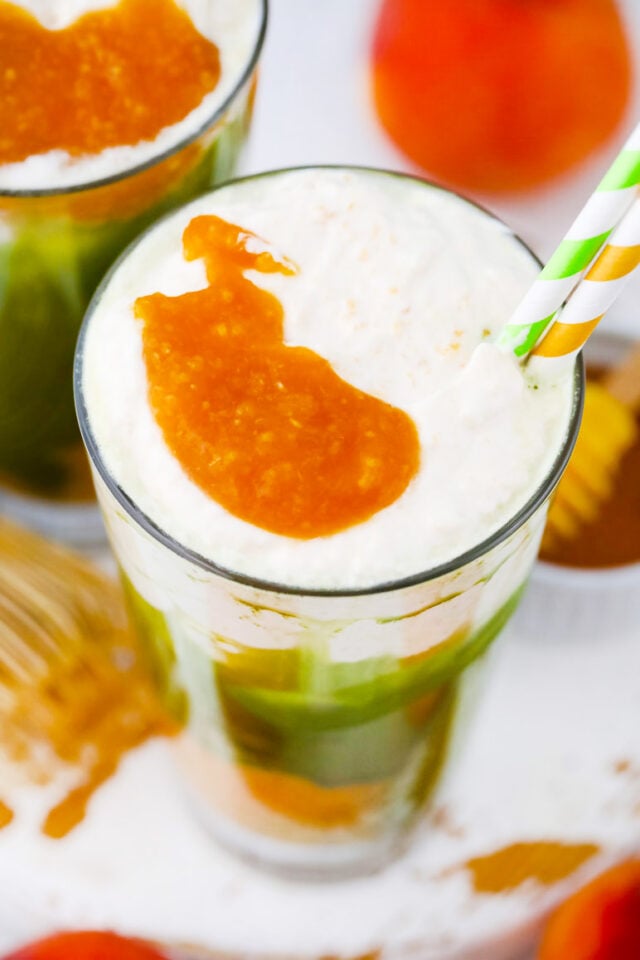 Peach matcha freddo with peach puree and whipped cream.