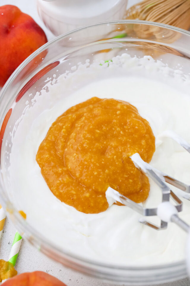 Adding peach puree to whipped cream.