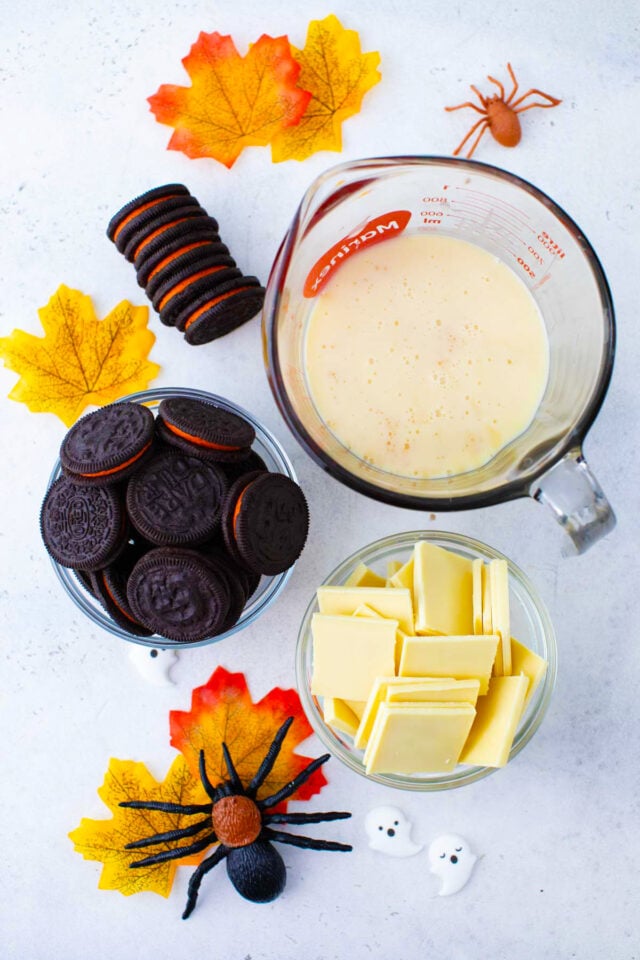 Overhead shot of Halloween Oreo fudge ingredients in bowls on a table.