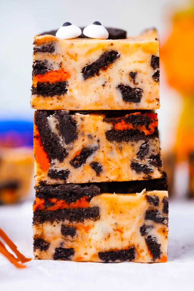 A stack of orange  Halloween Oreo fudge with Halloween Oreos.