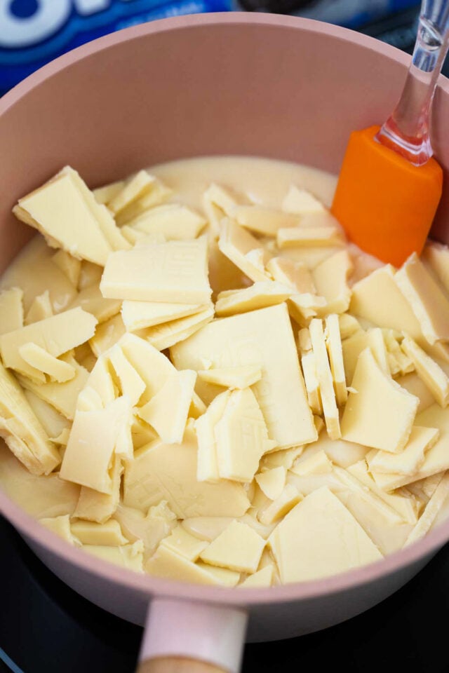 Chopped white chocolate and condensed milk in a sasucepan.